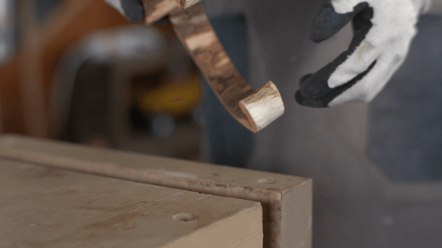 Woodcraft artisan securing a wooden piece on a work clamp