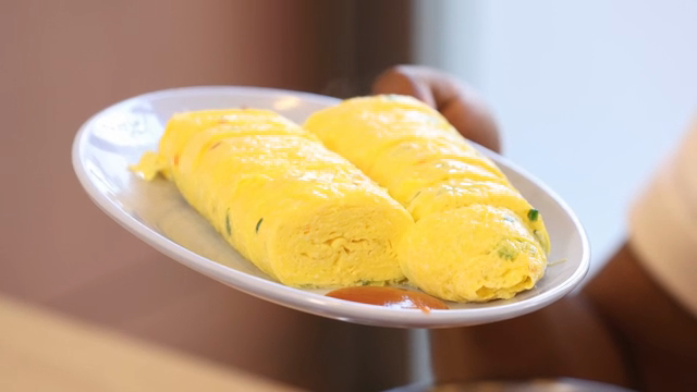 Freshly cooked rolled omelet on a plate