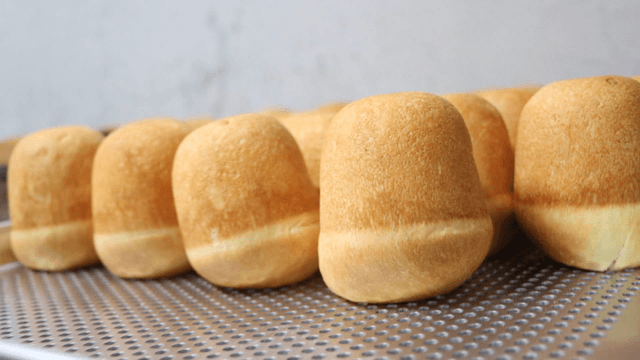 Freshly baked bread being prepared in a kitchen