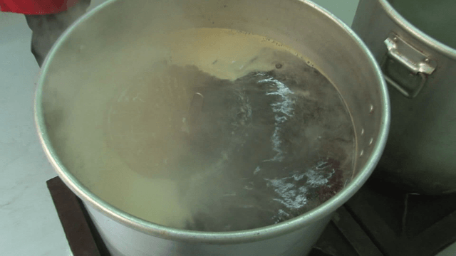 A large pot of boiling liquid in a kitchen