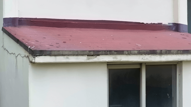 Exterior view of a building with a red roof