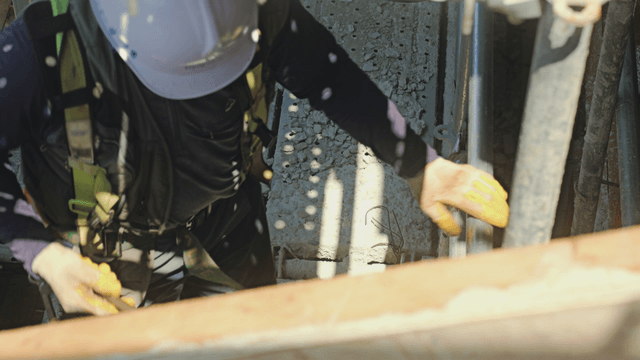 Construction worker using tools on site