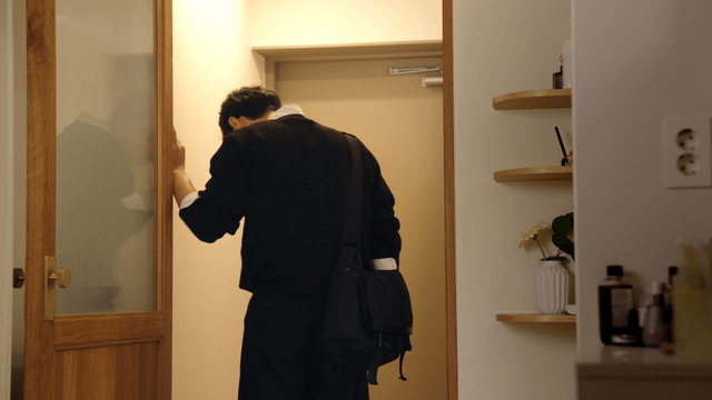 Arguing newlyweds stepping into apartment hallway