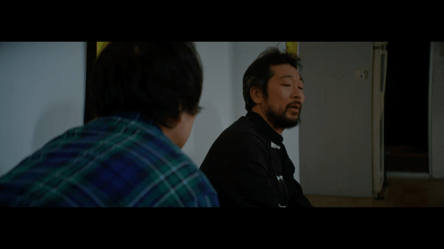 Two men having a conversation indoors