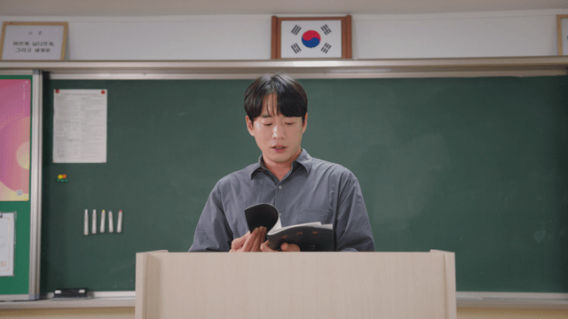 Teacher leaving the classroom holding the attendance book after morning assembly