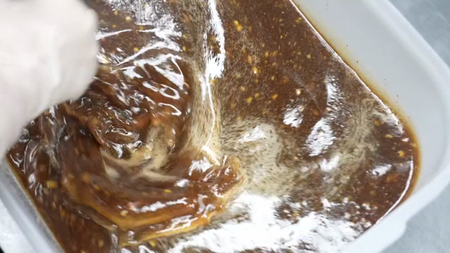 Mixing sauce in a container with a spatula