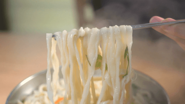 Handmade noodle soup steaming in pot