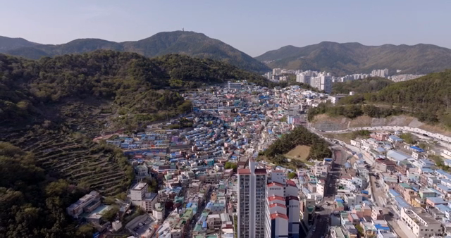 Colorful hillside village with mountains