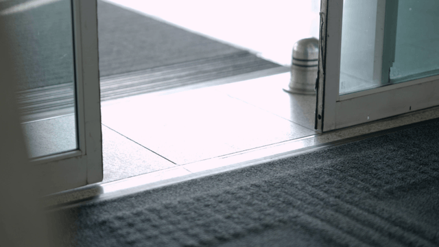 People entering through a glass door