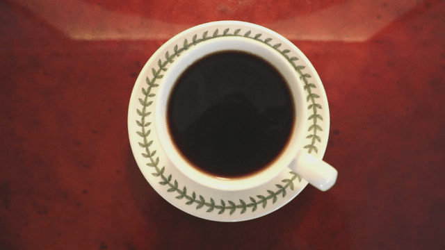 A cup of black coffee on a wooden table