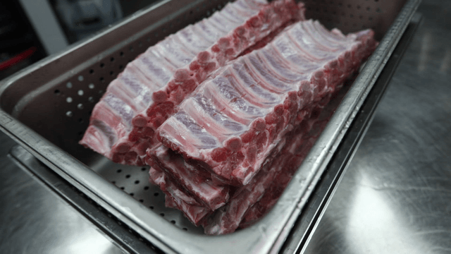 Raw pork ribs in metal container
