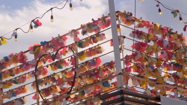 Colorful love locks hanging on a fence