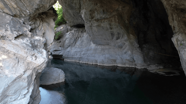Clear water flowing beneath quiet cave