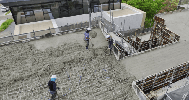 Construction workers pouring concrete