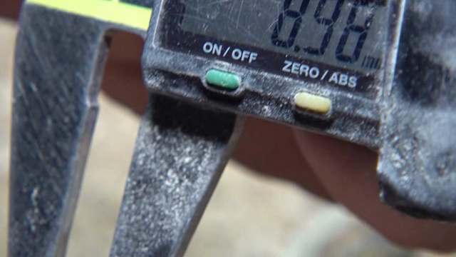 Caliper measuring a wooden object