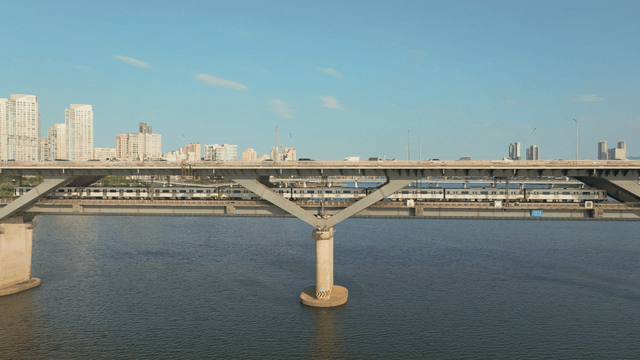 A bridge over a river with a subway passing