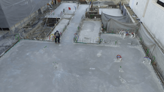 Construction site with workers on concrete