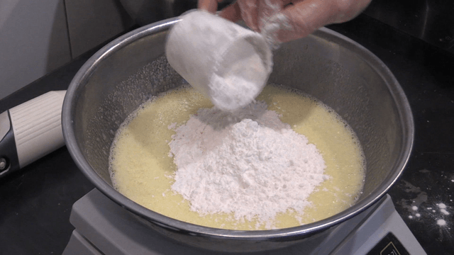 Flour finely poured into mixing bowl on scale