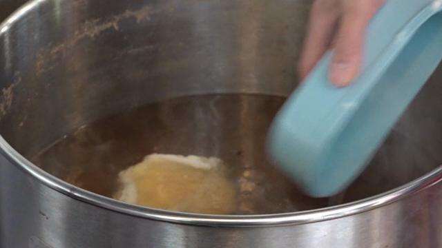 Grated yam being added to a pot