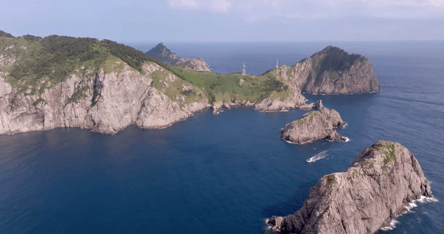 Rocky island with lush greenery and ocean