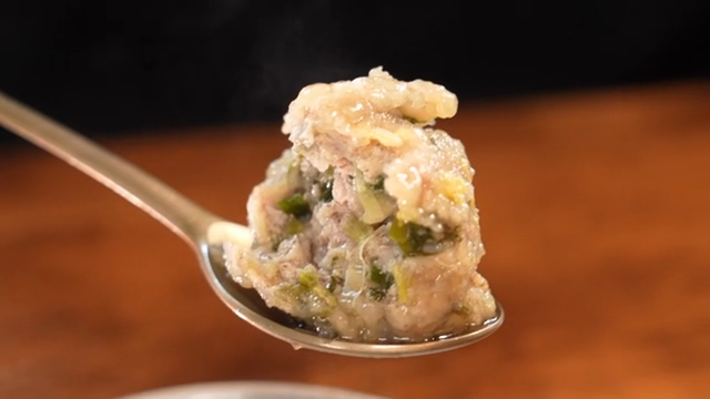 Steaming Korean dumpling on a spoon