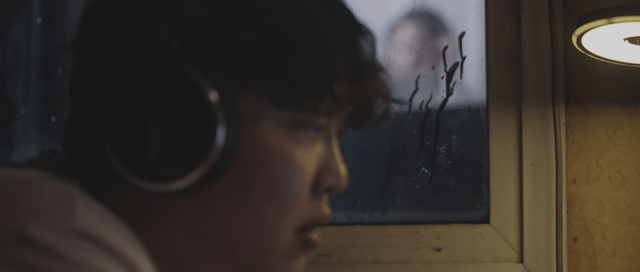 Man looking through a window at a woman
