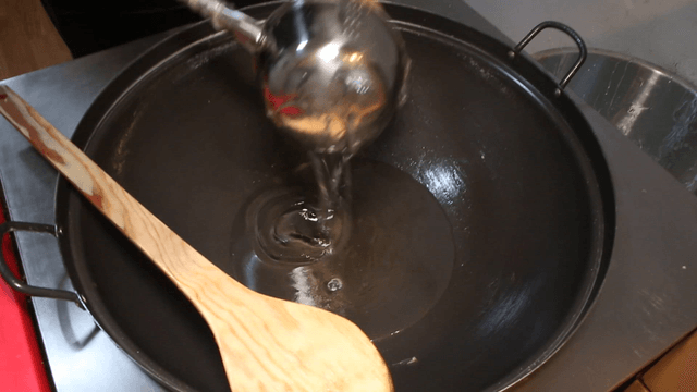 Pouring honey into a large cooking pot