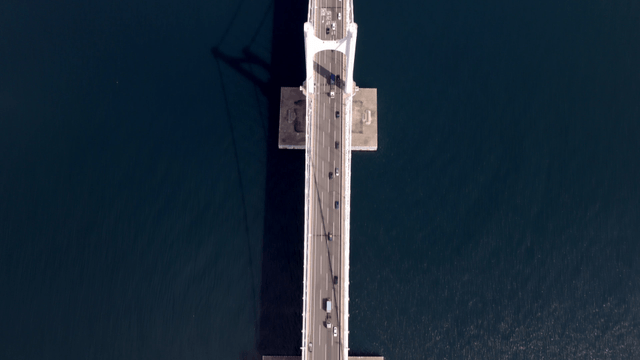 Bridge over a coastal city with skyscrapers