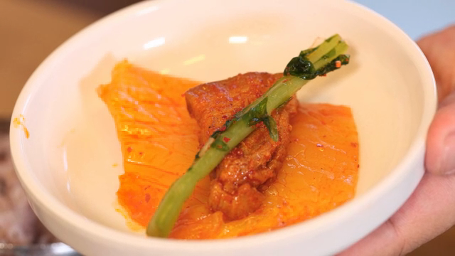 Kimchi and meat in a bowl with chopsticks
