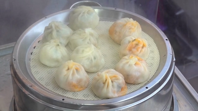 Steamed dumplings being prepared outdoors