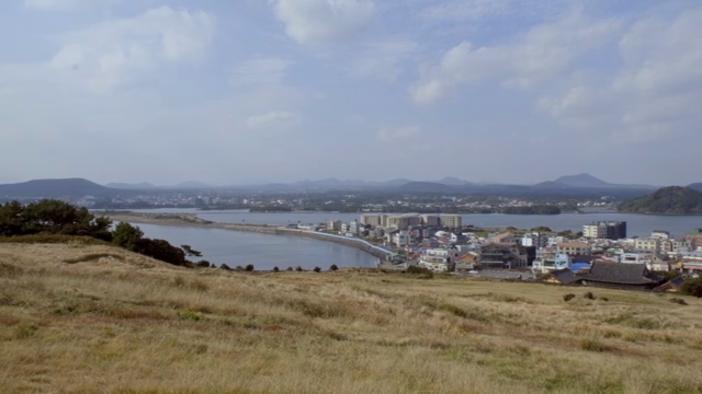 A coastal city with distant mountains