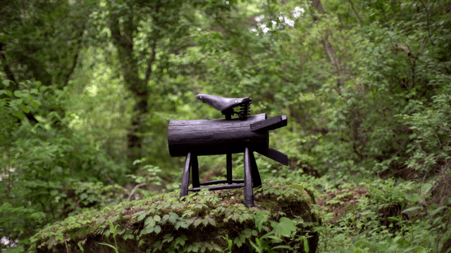 Wooden sculpture in a lush green forest