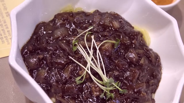 Noodles in Black Bean Sauce served in a white bowl