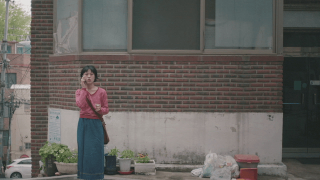 Woman talking on the phone outside a building