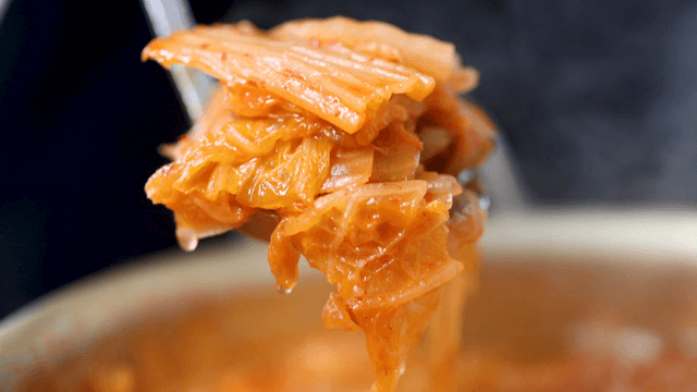 Boiling kimchi stew scooped with ladle