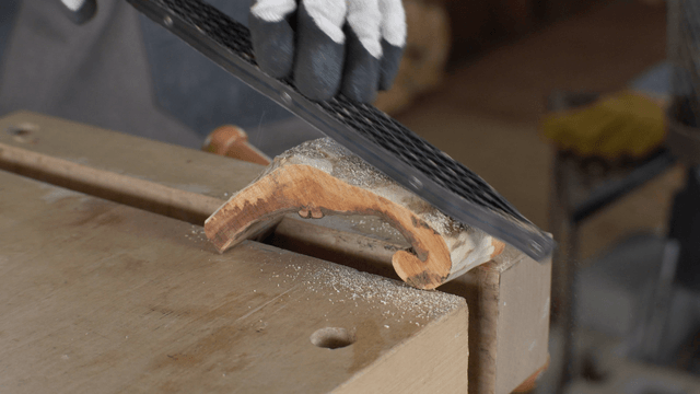 Wood being shaped with a woodworking file