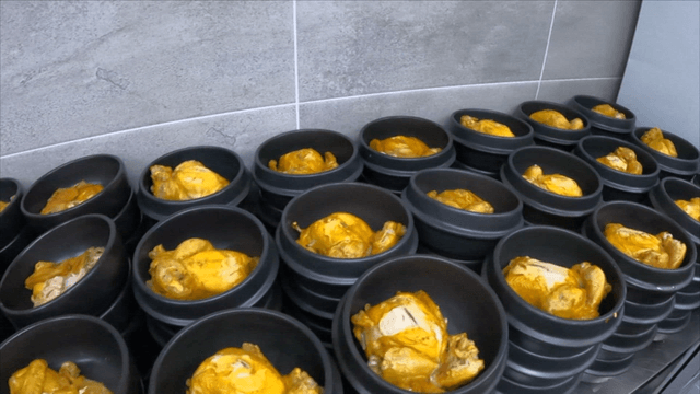 Boiled chickens placed in multiple earthen pots