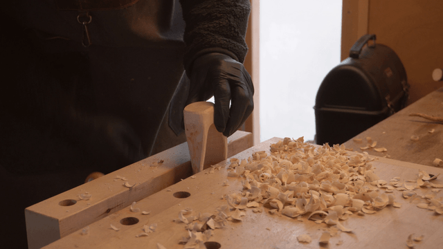 Wooden scoop head being fixed in a cozy workshop