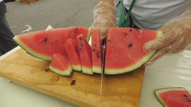 Fresh watermelon pieces sliced on roadside cutting board