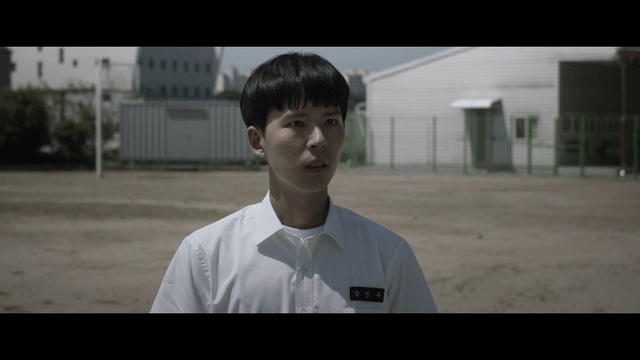 Student standing in a schoolyard
