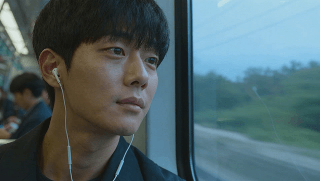 Young man listening to music on subway