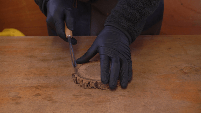 Chiseling wooden piece on workshop table
