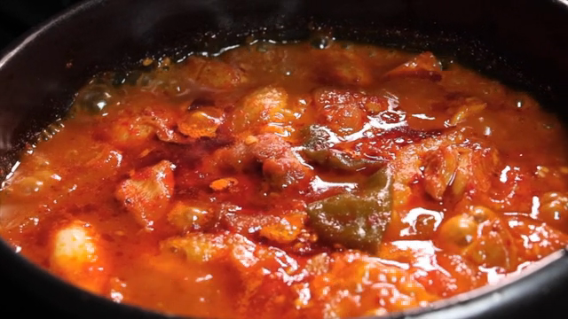 Spicy braised chicken boiling in a hot pot
