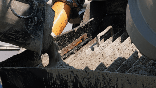 Concrete being poured into a mixer