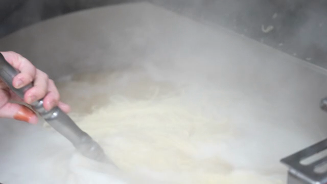 Noodles being cooked in boiling water