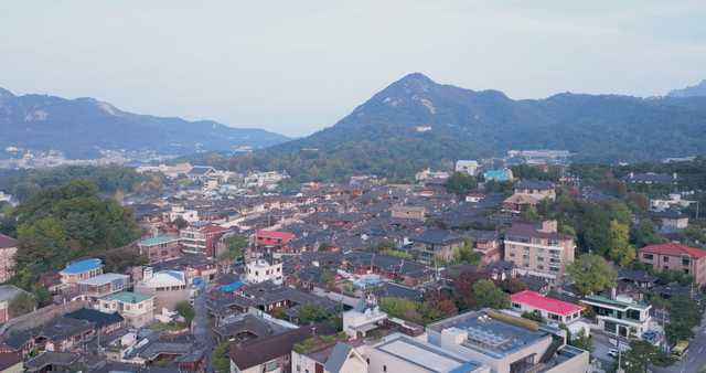 Traditional hanok village with mountains