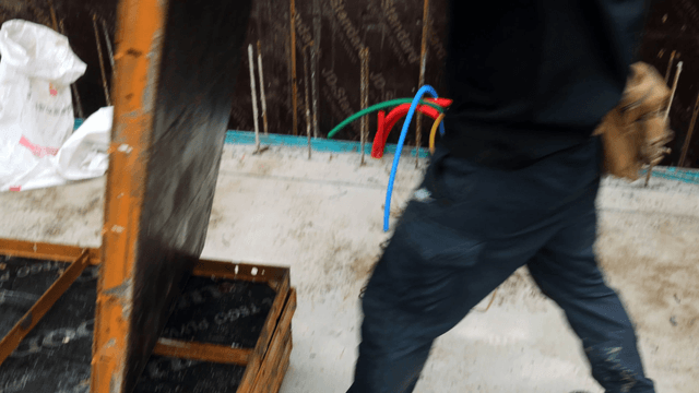 Workers handling construction materials