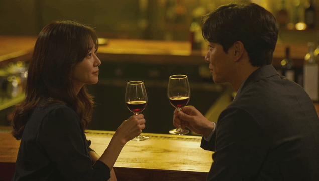Couple enjoying red wine in a dimly lit bar
