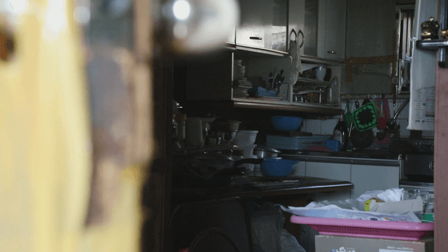 Cluttered kitchen with various utensils