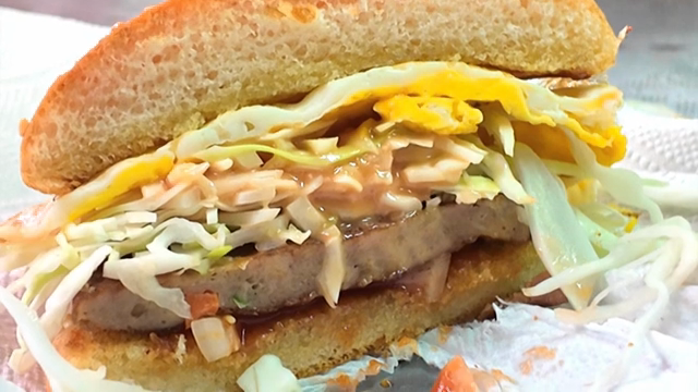 Cross-section of a burger with egg and cabbage